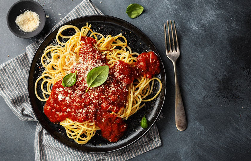 tasty-appetizing-spaghetti-pasta-tomato-sauce-served-plate-dark-background